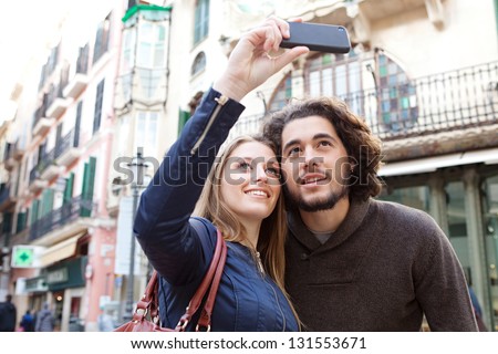 Close up portrait of a young tourist couple visiting a destination city and taking pictures of the classic buildings while on vacation in Europe Close up portrait of a young tourist couple visiting a destination city and taking pictures of the classic buildings while on vacation in Europe