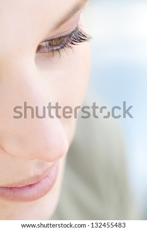 Over Head Close Up Beauty Portrait Of A Young Caucasian Healthy Woman Face And Eye Looking Down With Long Eyelashes.
