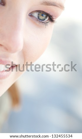 Close up beauty portrait of a young caucasian healthy woman eye looking down with lush and long eyelashes.