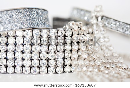 Close up detail still life view of exclusive and luxurious diamond bracelets, engagement rings and earrings. A multiple quality diamond detail jewelry shining and sparkling with light, interior.
