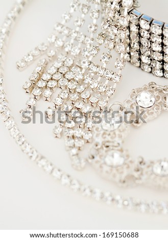 Close up still life view of exclusive and luxurious diamond bracelets, engagement rings, necklaces and earrings. A multiple quality diamond detail jewelry shining and sparkling with light, interior.
