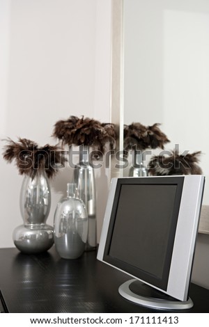 Still life view of high technology in a smart living room with a flat screen tv on a wooden table in a luxury home. Elegant hotel bedroom interior with technology.