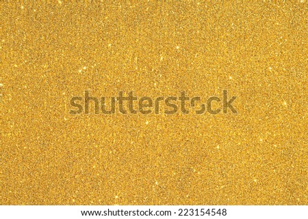 Abstract detail background of a vivid bright gold glitter shining and sparkling with texture. Galaxies and stars, full frame yellow noise color backdrop element.