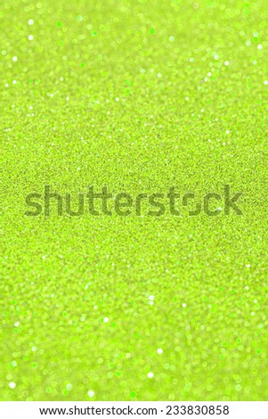 Abstract green glitter festive background texture with shining glitter stars. Full frame acidic yellow color christmas detail with blurred areas. Artistic colorful background drop frame.