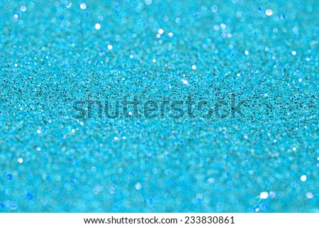 Abstract sky blue glitter festive background texture with shining glitter stars. Full frame cyan color christmas detail with blurred areas. Artistic colorful background drop frame.