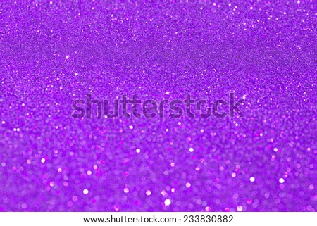 Abstract purple glitter festive background texture with shining glitter stars. Full frame violet color christmas detail with blurred areas. Artistic colorful background drop frame.