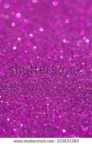 Abstract pink glitter festive background texture with shining glitter stars. Full frame fuchsia color christmas detail with blurred areas. Artistic colorful background drop frame.