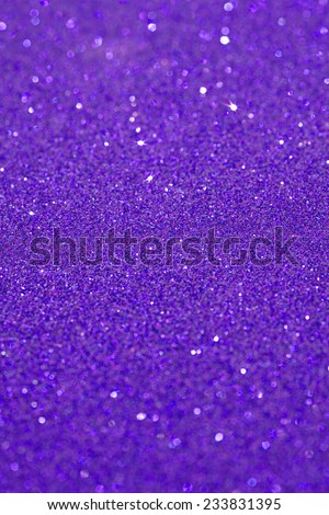 Abstract purple glitter festive background texture with shining glitter stars. Full frame blue color christmas detail with blurred areas. Artistic colorful background drop frame.