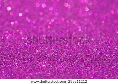 Abstract pink glitter festive background texture with shining glittering stars. Full frame magenta color christmas detail with blurred areas. Artistic colorful background drop frame space.