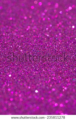 Abstract pink glitter festive background texture with shining glitter stars. Full frame fuchsia color christmas detail with blurred areas. Artistic colorful background drop frame space.