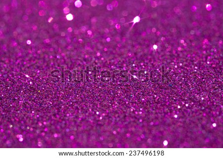 Abstract pink glitter festive background texture with shining glittering stars. Full frame magenta color christmas detail with blurred areas. Artistic colorful background drop frame space.