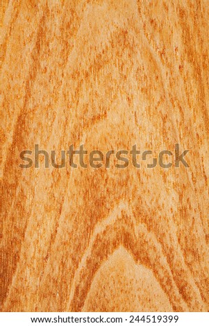 Close up detail view of a textured teak wood background with a golden rich color. Carpentry and organic natural materials and pattern backdrop. Full frame cut of wood with vertical lines and knots.