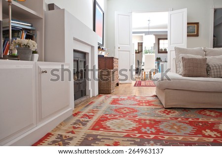 Low perspective still life of interior design home living room with a comfortable white sofa with cushions, and quality carpets, interior. Aspirational relaxing home family room, indoors lifestyle.