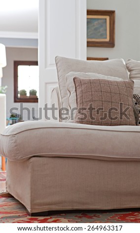 Low perspective still life view of interior design home living room with a comfortable white sofa with cushions, house interior. Aspirational and relaxing home family room, indoors lifestyle.