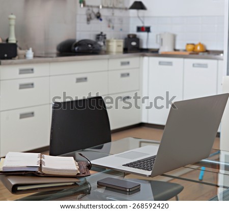 Still life home interior of family kitchen room with technology and glass table in a working from home setting. Elegant house living indoors. Aspirational luxurious lifestyle interior space property.