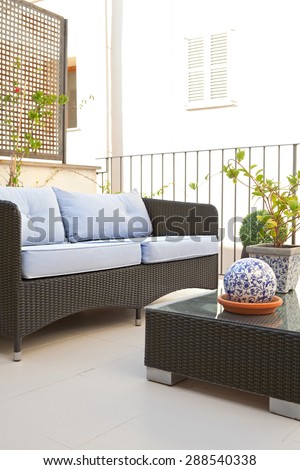 Still life of a home outdoors living room and terrace garden outdoors eating area with table and chairs, in a stylish graphic house, relaxing area. Home living, empty space, aspirational lifestyle.