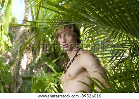 Caucasian man standing in a tropical forest.