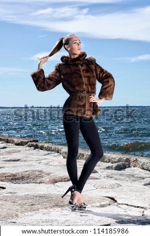 Fashion shoot of young attractive woman in fur dress