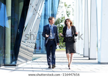 Business People Walking And Talking In The Street