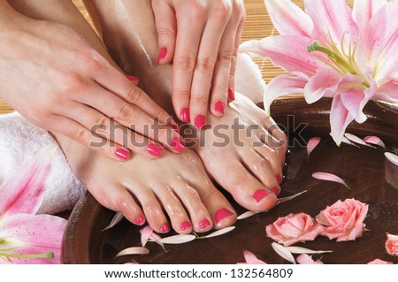 Spa background with a beautiful legs, flowers, petals and ceramic bowl