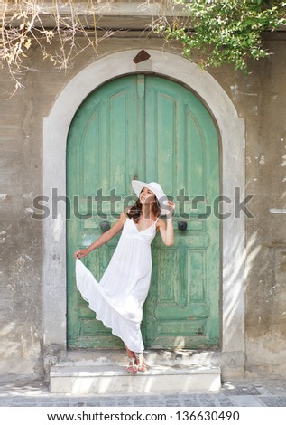 Young and beautiful lady walking down the ancient street
