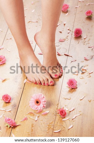 Spa background with a beautiful legs, flowers and petals