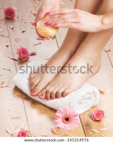 Beautiful female legs in spa composition