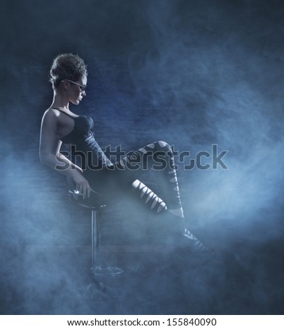 Police styled photo of young sexy woman over smoky background