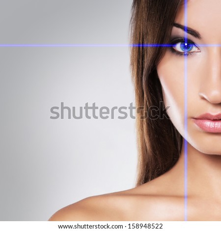 Close-Up Portrait Of Young And Beautiful Woman With The Virtual Hologram On Her Eyes (Laser Medicine And Security Technology Concept)