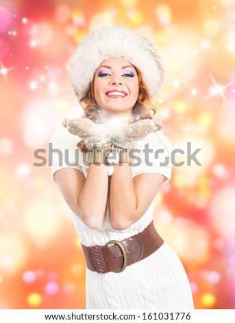 Young and beautiful woman in traditional winter dress over abstract Christmas background