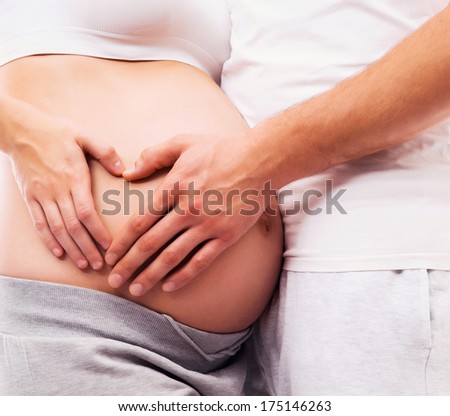 Young attractive couple: pregnant mother and happy father