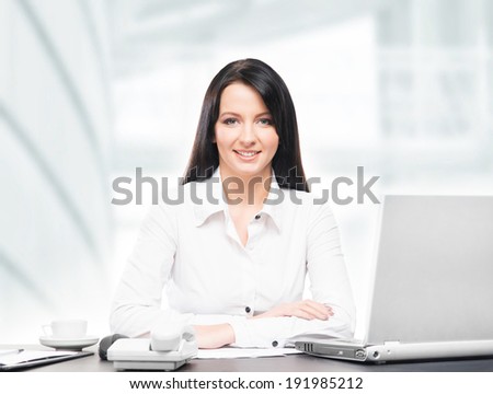 Young and attractive business woman working in office