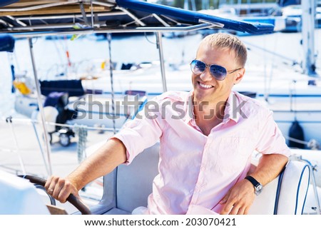Young and handsome man on luxury yacht