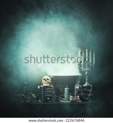 Halloween background with a lot of different witchcraft tools: skull, candles, book, poison and smoke
