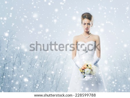 Gorgeous bride in wedding dress over the Christmas background
