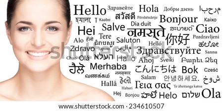 Portrait of a woman over the background with a different world languages (language school concept)