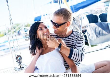 Young, rich and attractive couple on a sailing boat