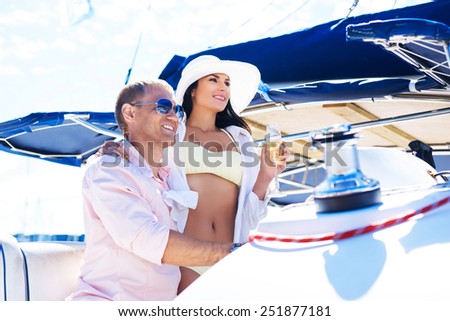 Young, attractive and rich couple have a party on a luxury boat