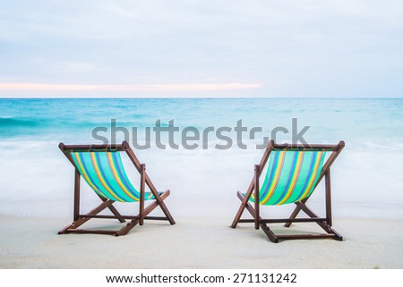 Lounge chairs on a tropical beach at summer