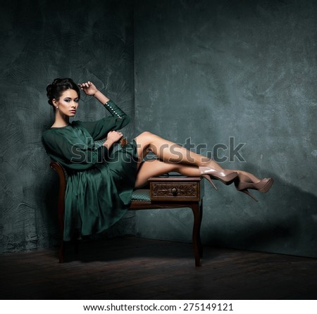 Young and beautiful fashion model over vintage and shabby background