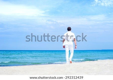 Young and handsome man on a summer beach