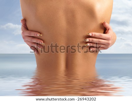 Naked female back and fingers with bright manicure isolated on white