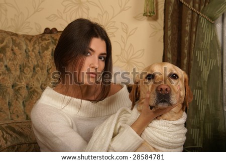Attractive woman with the dog in the luxury interior