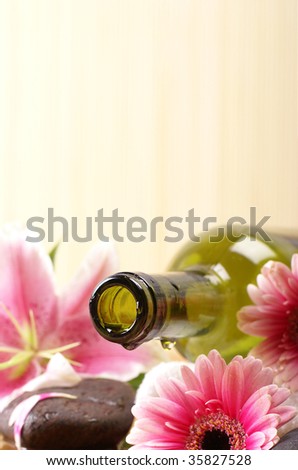 Spa composition (Warning! Only the bottle neck and a part of the flower are in focus)