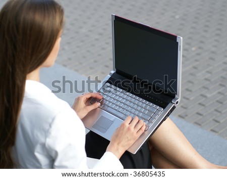 Businesswoman with the notebook (rear view, focus on the keypad)