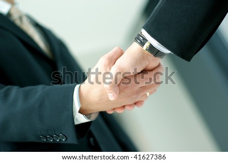 Closeup of business people shaking hands over