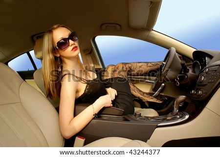 Sexy woman in a luxury car