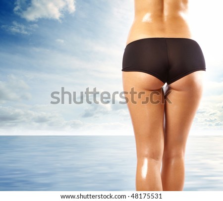 Back and ass of beautiful woman over sea background stock photo