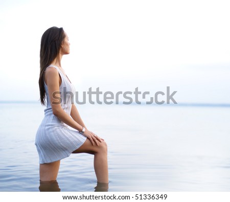 Young sexy lady standing in the warm water