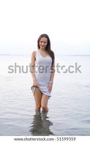 Young sexy lady standing in the warm water